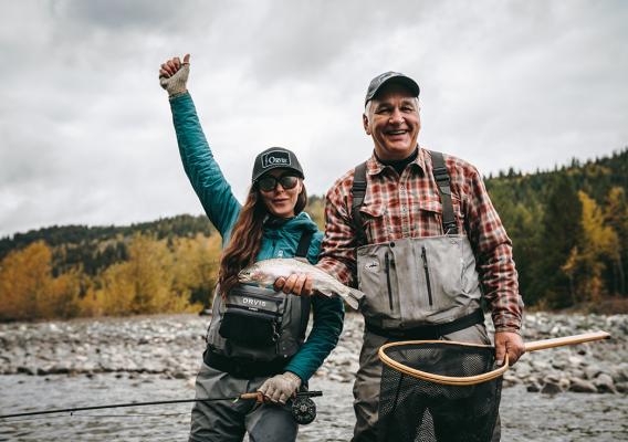 Guide, Doug Mooring and fisherwoman holding a fish in excitement
