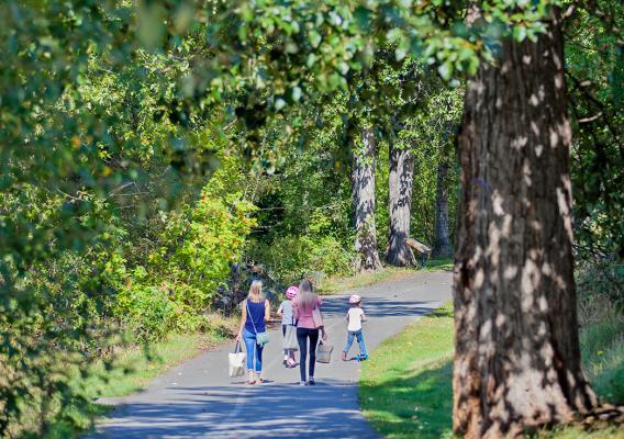 Mothers and daughters walking on paved Riverfront Trail